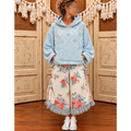 Powder-blue textured floral hoodie styled with cream floral wide-leg pants